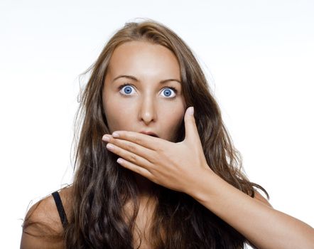 surprised and shocked girl covering moth with her hand - isolated on white