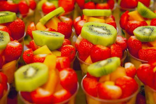bowls of fresh assorted fruits - strawberry, kiwi and ananas