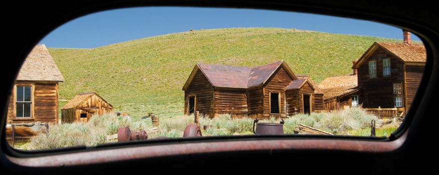 Abandoned buildings viewed through from a mirror of a car, Bodie Ghost Town, Bodie State Historic Park, Mono County, California, USA