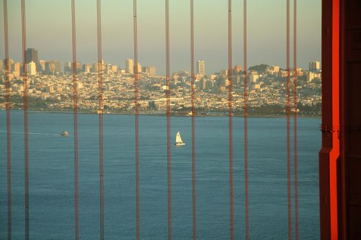 Scenic view of San Francisco skyline and Bay viewed through cables of Golden Gate Bridge, California, U.S.A.