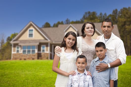 Happy Young Hispanic Family in Front of Their New Home.