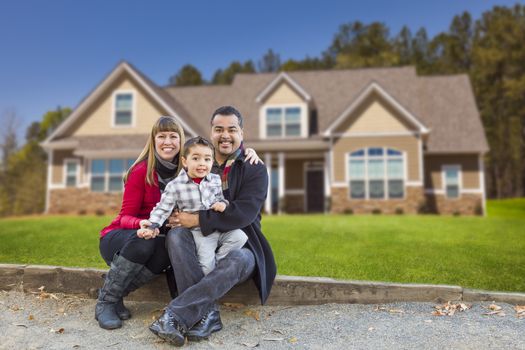 Happy Mixed Race Family in Front of Their Beautiful New Home.