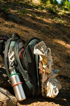 Open hikers rucksack showing equipment on hillside trail to Taft Point in Yosemite Park, California, U.S.A.