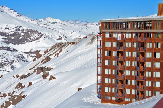 Large hotel on snowy mountainside in ski resort, Chile.