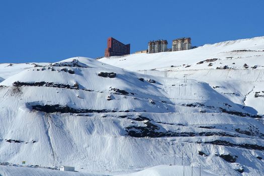 Scenic view of hotels on summit on snowy mountainside in Chile.