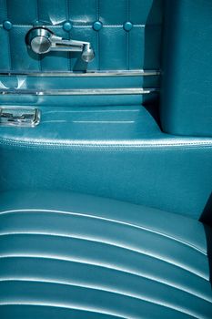 Detail of the interior of a refurbished classic car with blue leather.