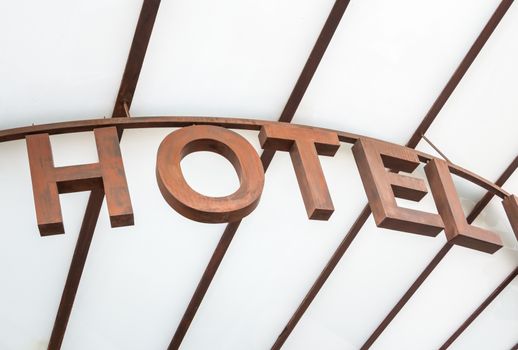Modern hotel sign over a glass canopy entrance