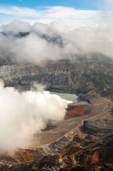 Main crater of the Poas Volcano showing the inner crater lagoon, fumaroles, main dome, ash layers and old crater.