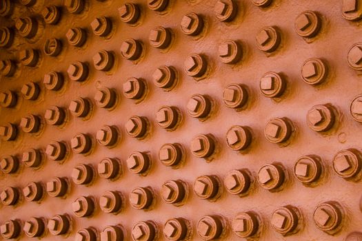 Abstract background of nuts and bolts on old locomotive train.