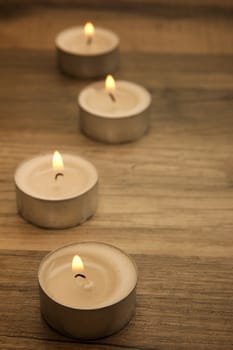 several tealights with wooden background