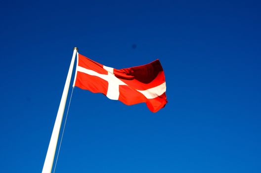 Danish flag waves in the breeze on a summer day