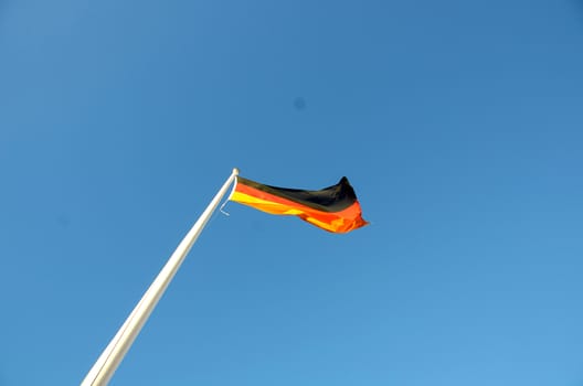 German flag on a sunny day against a blue sky