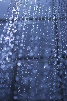 running water from a shower head with water drops