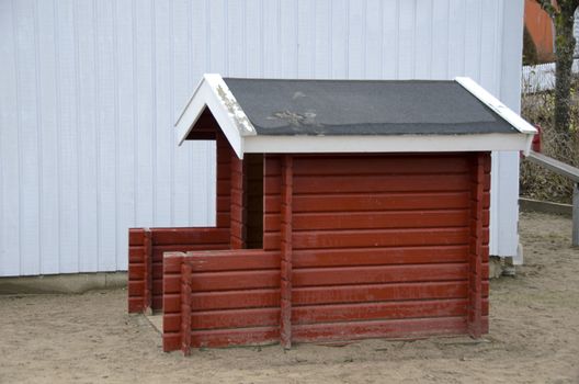 A red small fine Playhouse on playground