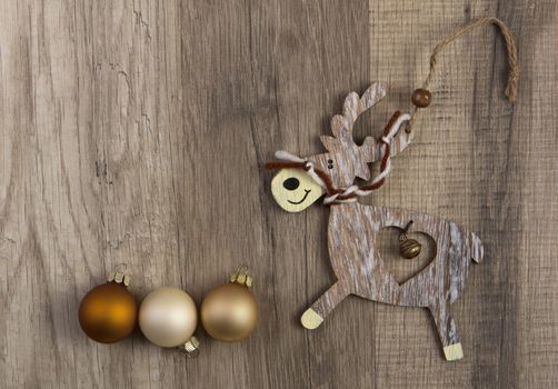 christmas baubles brown, moose on wooden background
