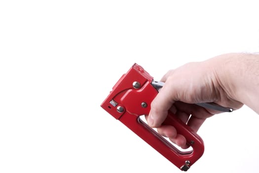 Construction stapler in a hand,  isolated on a white background