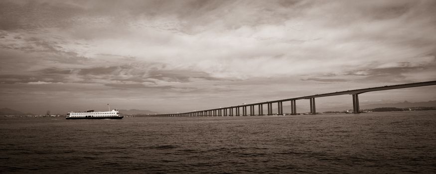 Panoramic black and white view of Rio de Janeiro to Niteroi bridge over Guanbara Bay, Brazil.