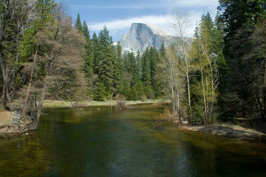 Scenic view of river in Yosemite National Park with Half Dome mountain in background, California, U.S.A.