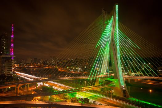 Scenic view of Octavio Frias de Oliveira bridge illuminated at night over Pinheiros river in Sao Paulo, Brazil.