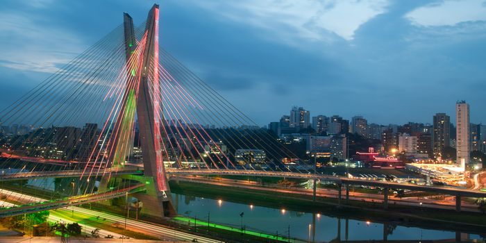 Scenic view of Octavio Frias de Oliveira bridge illuminated at night over Pinheiros river in Sao Paulo, Brazil.