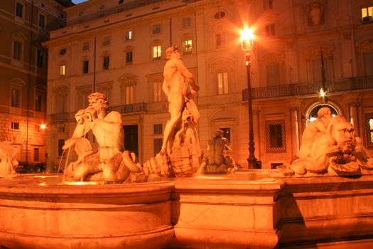 Statues at fountain at night, Fontana Del Moro, Piazza Navona, Rome, Rome Province, Lazio, Italy