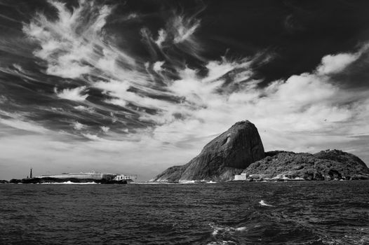 Black and white scenic view of Sugarloaf mountain at mouth of Guanabara Bay, Rio de Janeiro, Brazil.