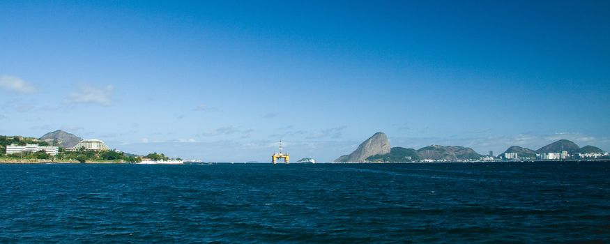 Distant view of Sugarloaf Mountain and Oil Rig in Rio De Janeiro, Brazil