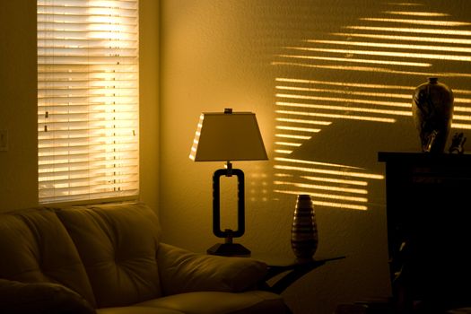 Living room wall illuminated by sunlight at late afternoon through a window blond.