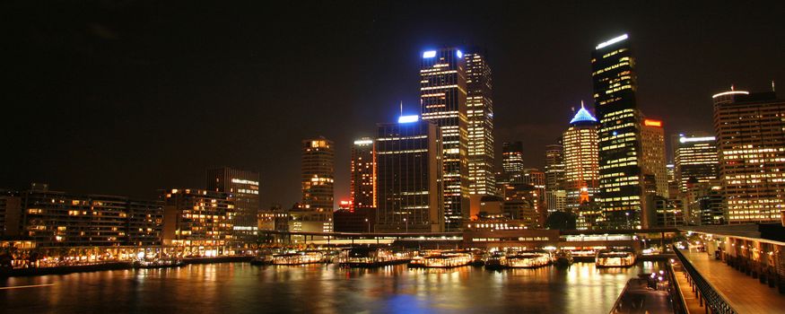 Scenic view of Sydney Harbor illuminated at night, Australia.