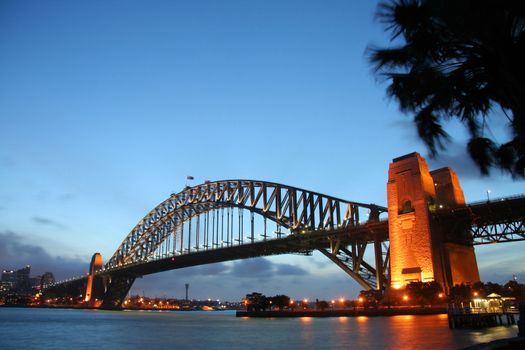 Scenic view of Sydney harbour bridge illuminated at dawn, Australia.