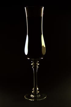 Natural silhouette from cast light on the edges of a tall champagne glass or flute.