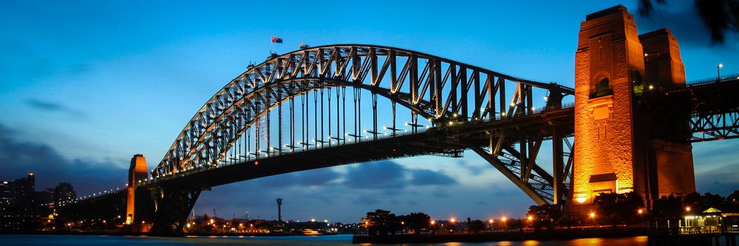 Scenic view of Sydney harbour bridge illuminated at dawn, Australia.