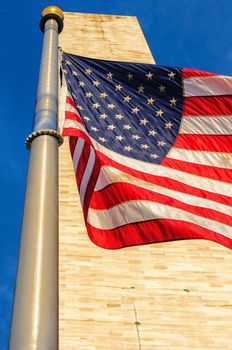 Low angle view of Washington Monument and American Flag, Washington DC, USA