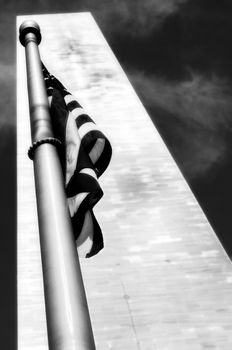 Low angle view of Washington Monument and American Flag, Washington DC, USA