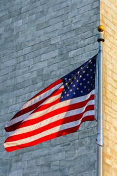 Low angle view of Washington Monument and American Flag, Washington DC, USA