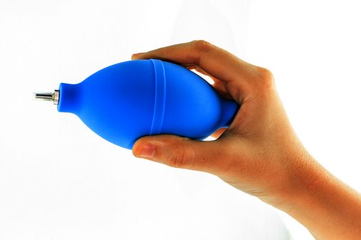 hand with air blower for cleaning camera