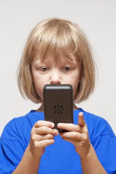 boy playing with handheld computer game - isolated on light gray