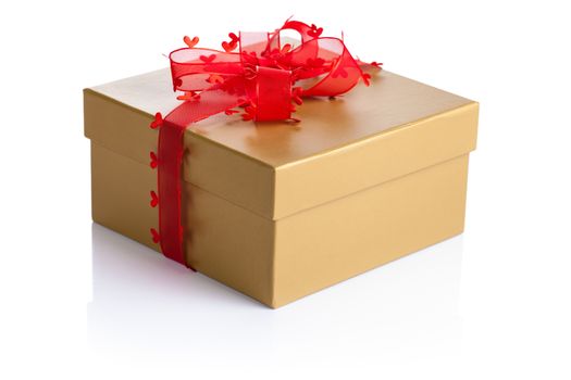 Golden gift box with red ribbon on white background
