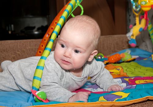 Close up shot of  baby creeping on a bed.