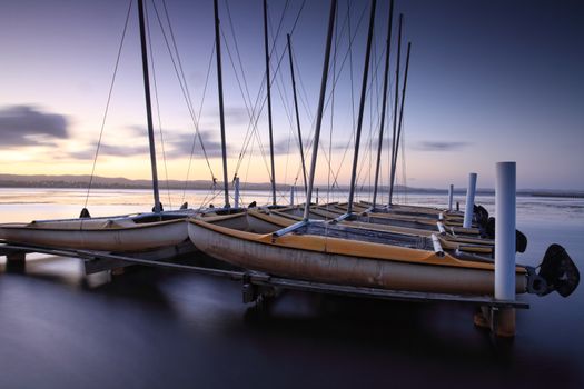 Catamarans moored on Tuggerah Lakes at Long Jetty, Australia after sundown. Long Exposure with lens filters