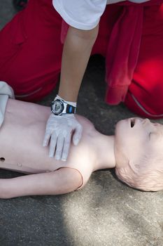 Paramedic demonstrates CPR on dummy