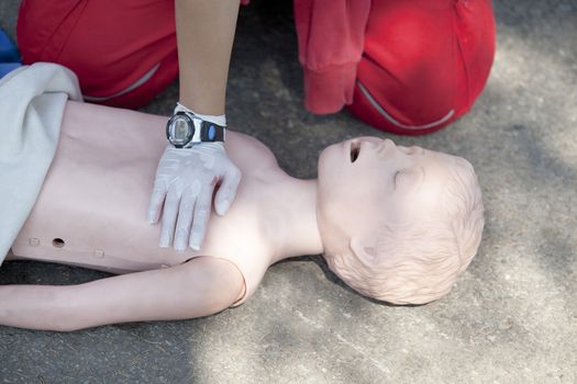 Paramedic demonstrates CPR on dummy