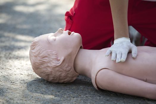 Paramedic demonstrates CPR on dummy