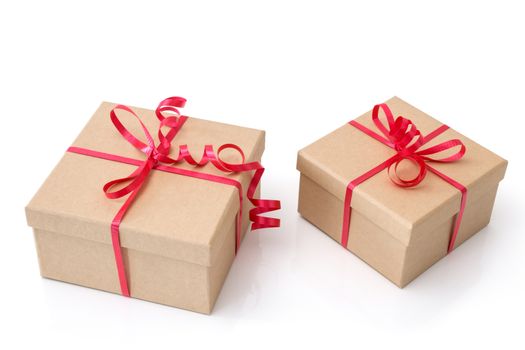 Two simple gift boxes with red ribbons, isolated on white background.