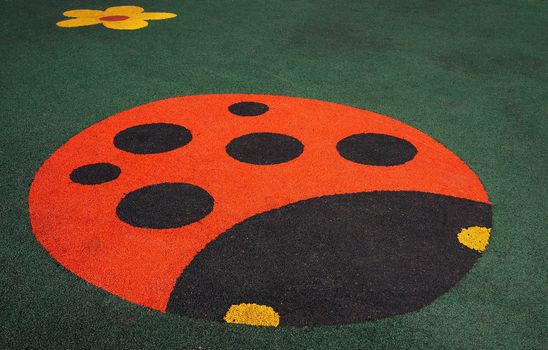 Floor covering children's playground with a ladybug                     