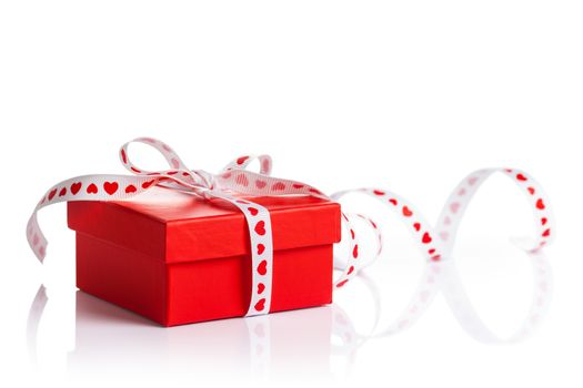 Red gift box with ribbon on white background