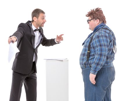 Elegant man in a suit and bow tie standing arguing with an overweight country yokel in braces trying to persuade him to move in a certain direction to no avail