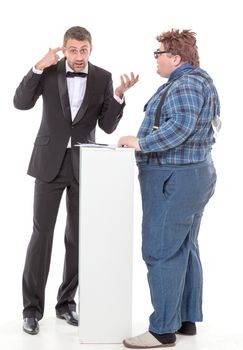 Elegant man in a tuxedo and bow tie standing arguing with an overweight country yokel