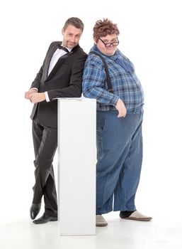 Elegant man in a tuxedo and bow tie standing with an overweight country yokel