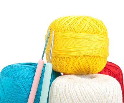 crochet needles and sewing thread in different colors